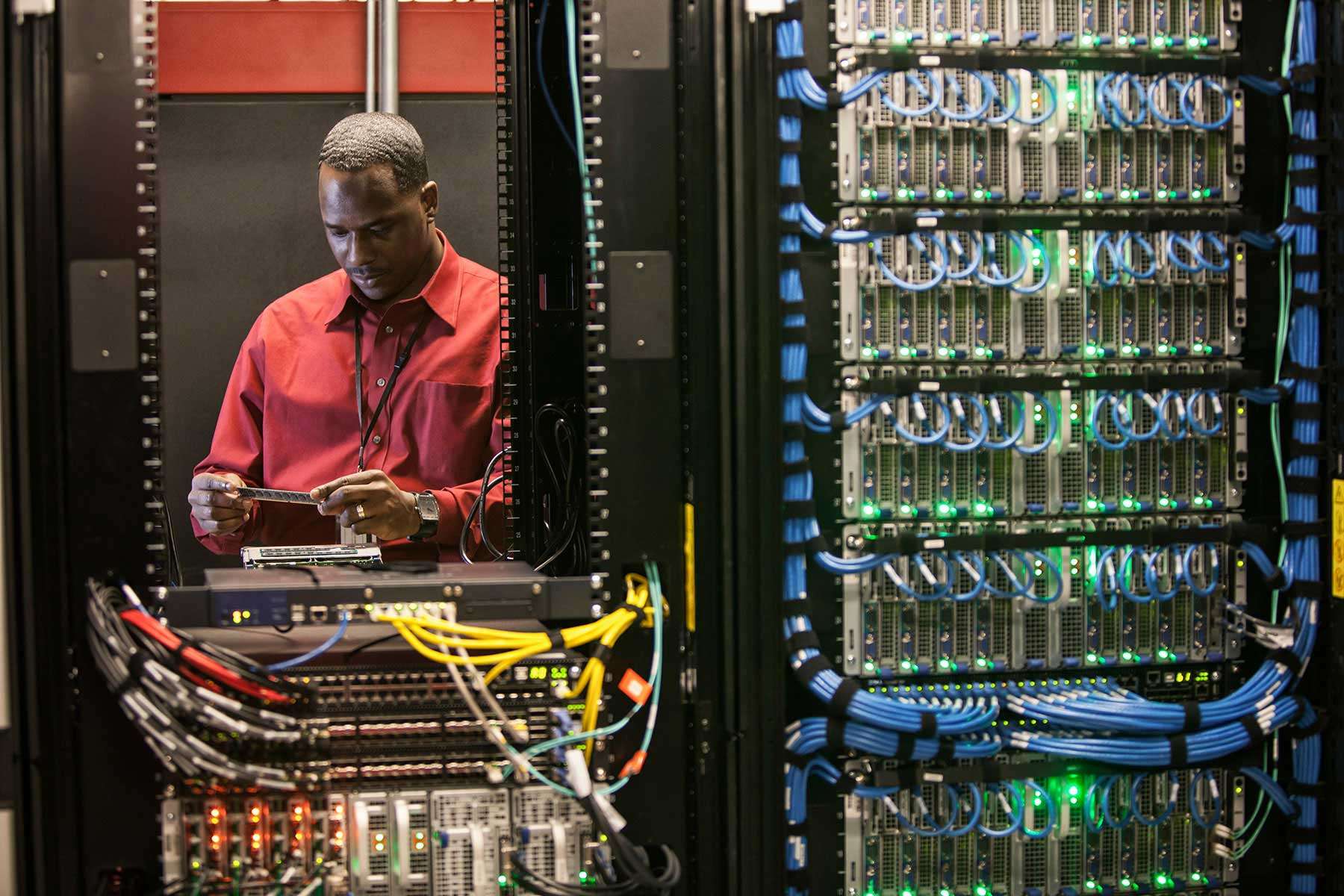 black-man-technician-working-on-computer-servers-i-626QK6H